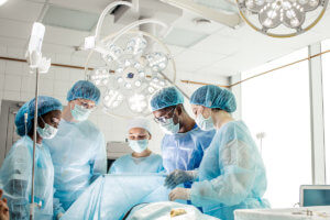 a dental team gathers around a patient and debate what is a dental emergency