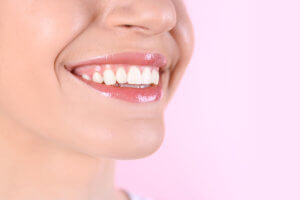 a woman smiles as she asks her doctor what is tooth enamel